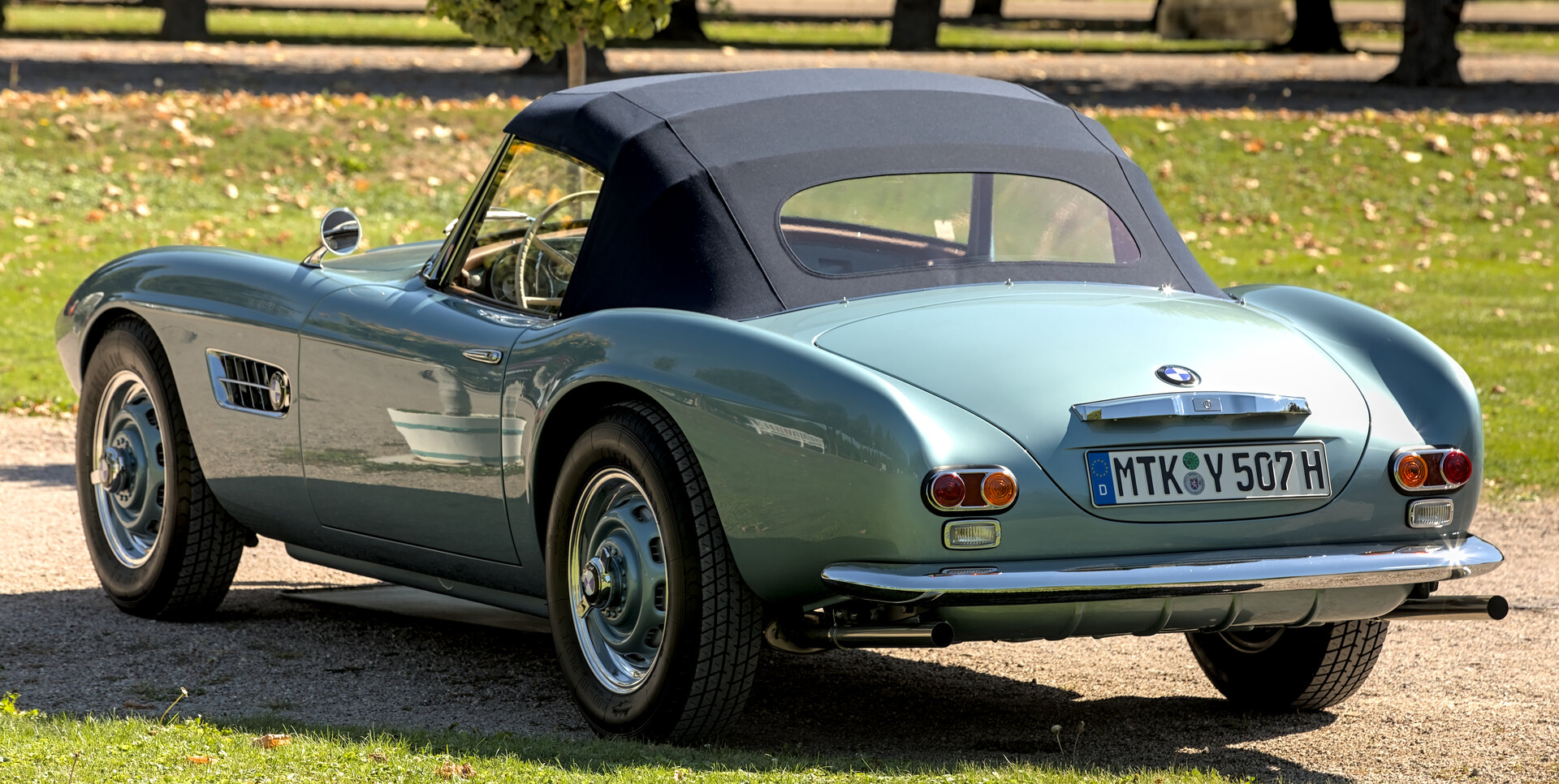 Rear three-quarter view of a pale blue BMW 507 Roadster