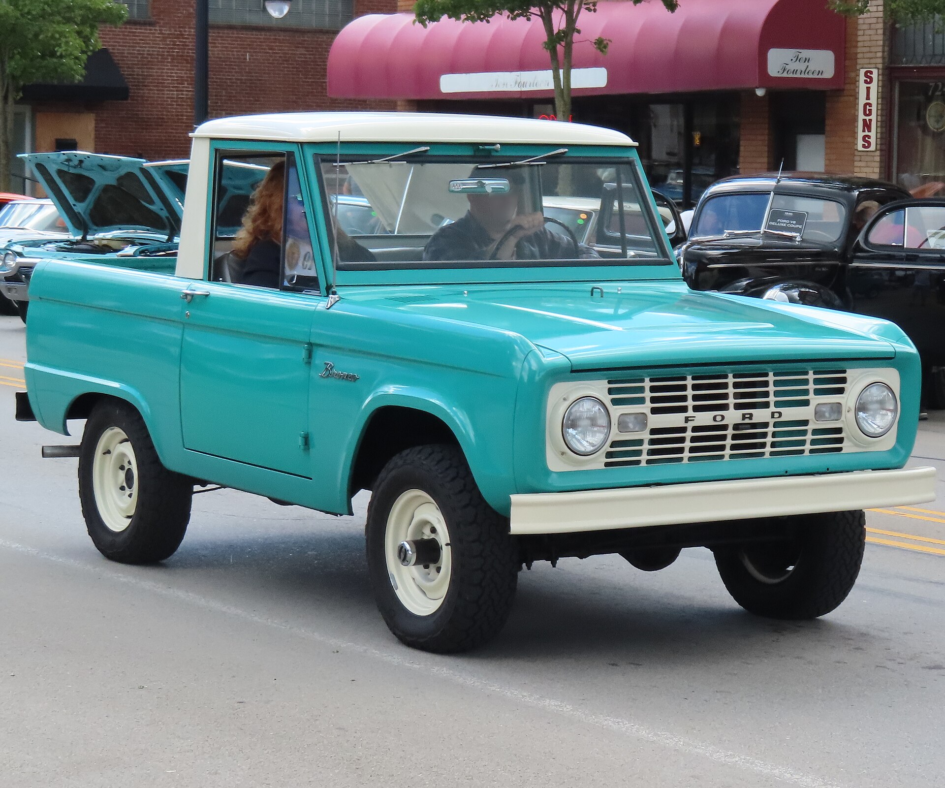 Front three-quarter view of a turquoise 1966 Ford Bronco Sports Utility