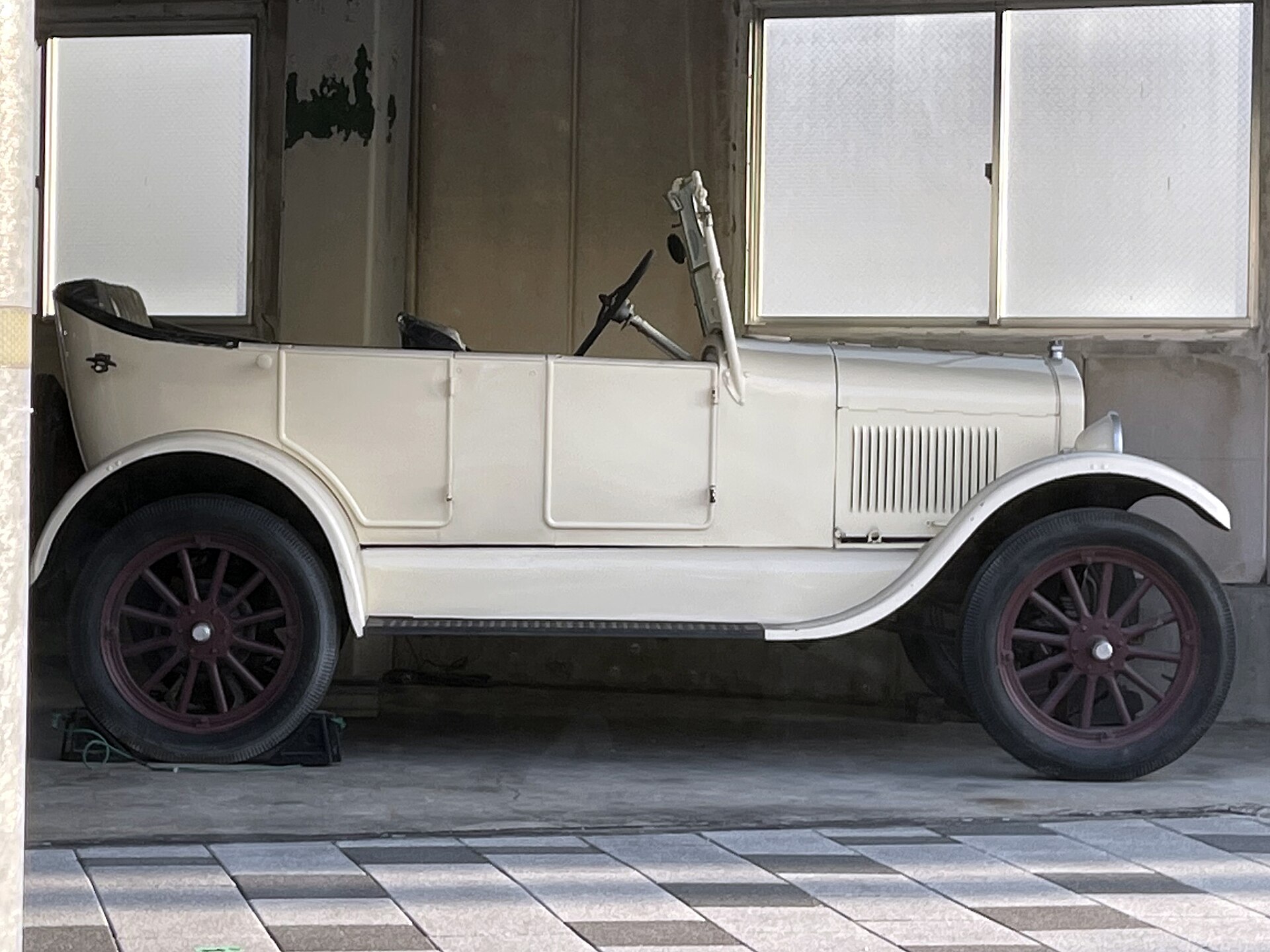 Side view of a white Ford Model T on display