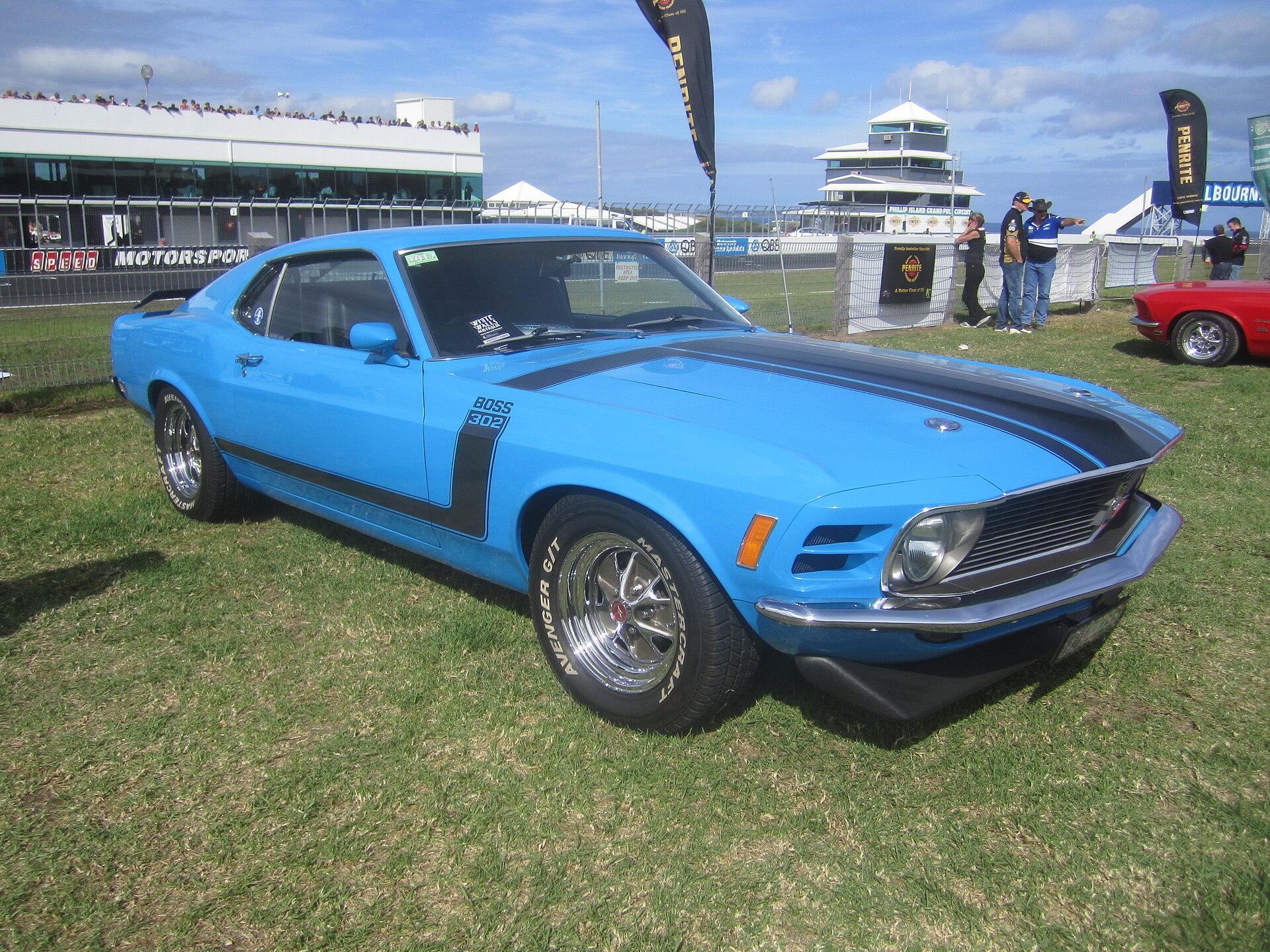 Front three-quarter view of a Grabber Blue 1970 Ford Mustang Boss 302