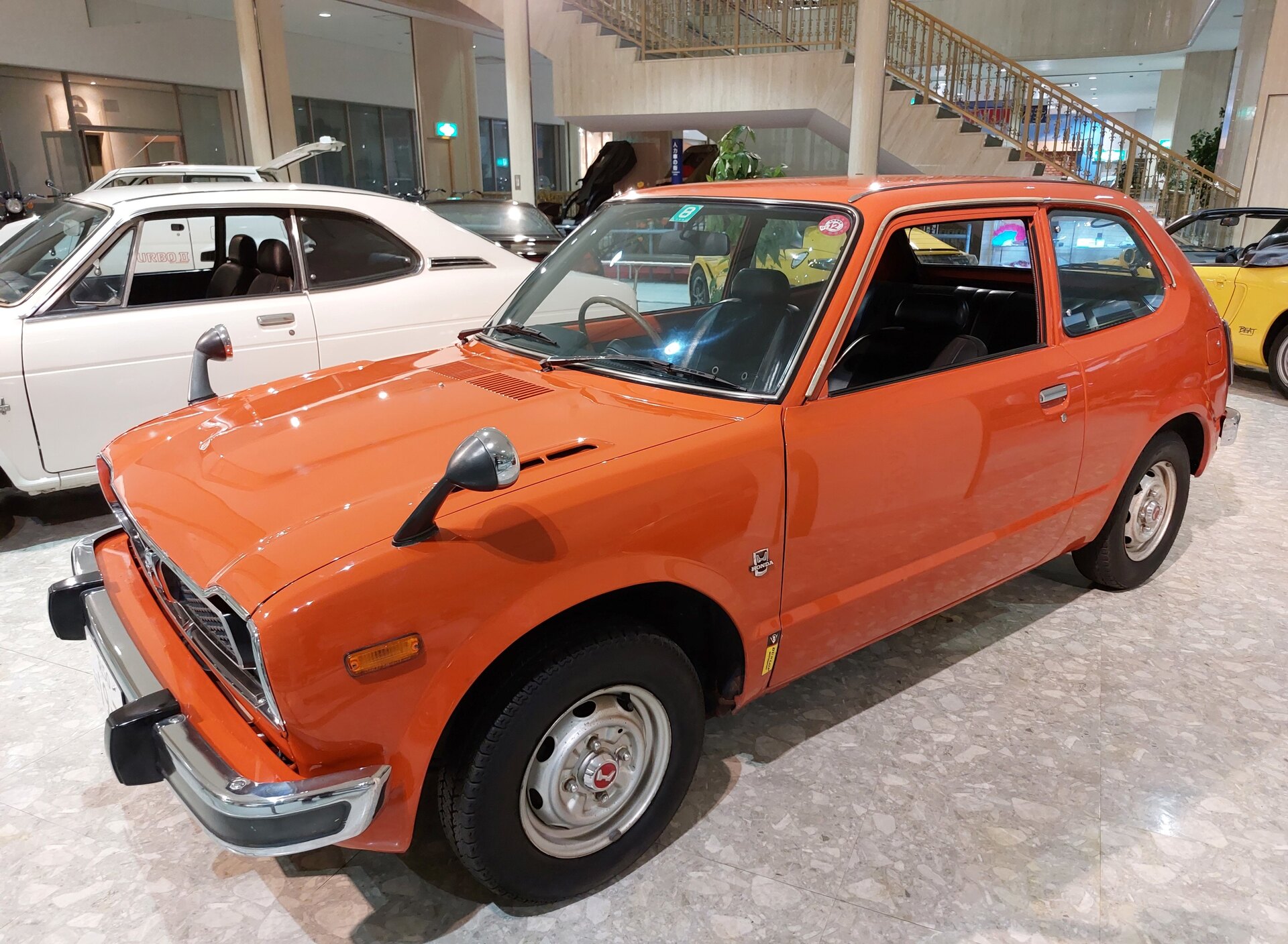Front three-quarter view of an orange first-generation Honda Civic RS three-door hatchback