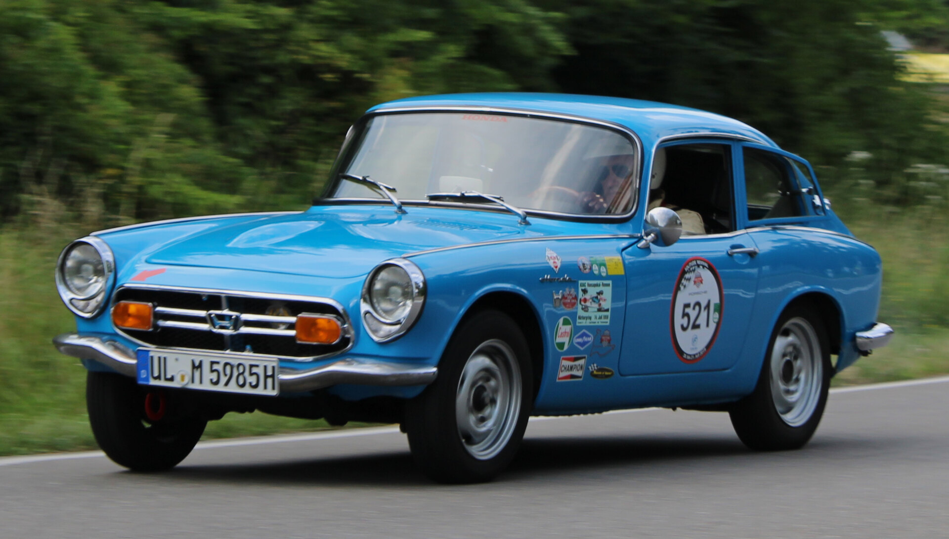 Front three-quarter view of a blue 1969 Honda S800 Coupe in motion