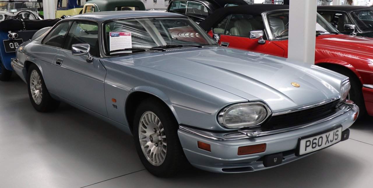 Silver Jaguar XJS V12 coupé P60 XJS viewed from the front and side in a museum