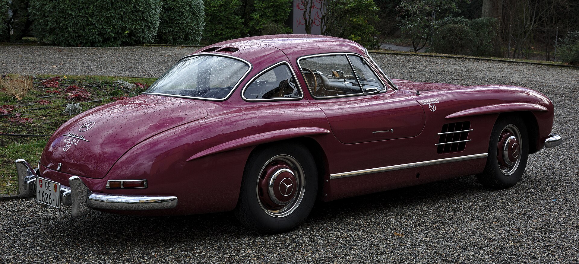 Rear three-quarter view of a burgundy Mercedes-Benz 300 SL Gullwing