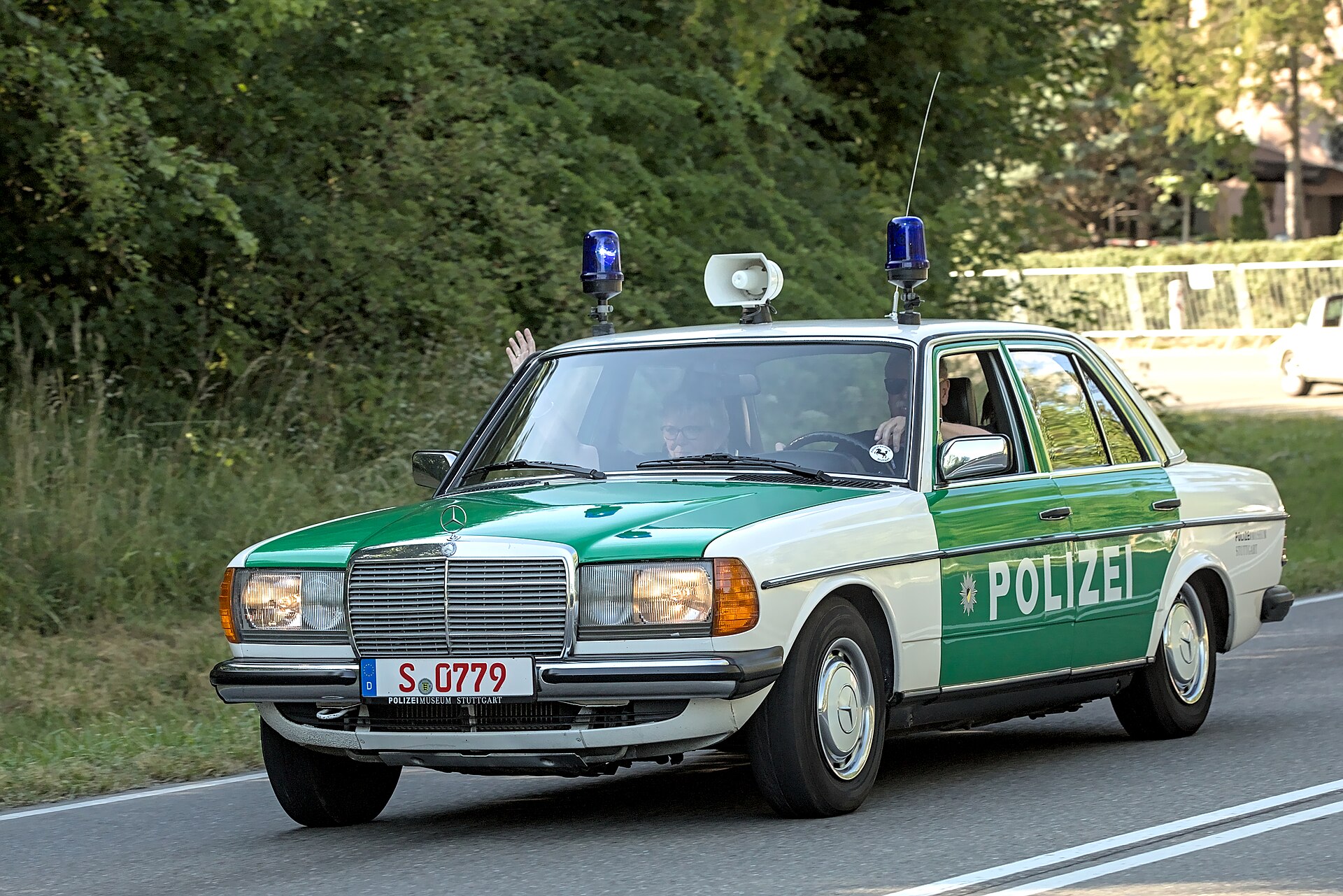 Front three-quarter view of a green and white Mercedes-Benz W123 police car