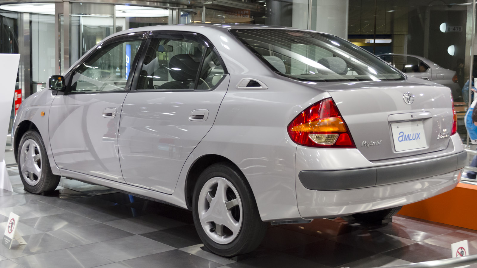 Rear three-quarter view of a silver first-generation Toyota Prius