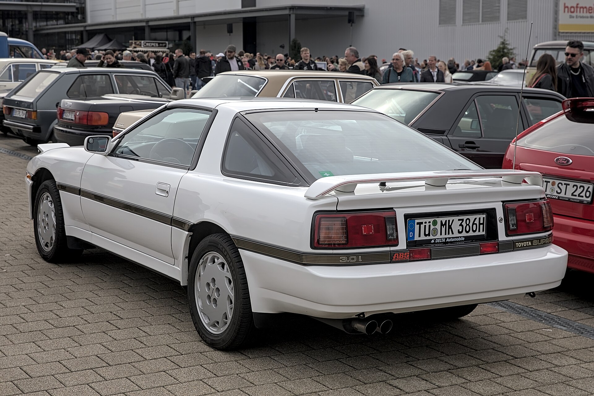 Rear three-quarter view of a white third-generation Toyota Supra A70