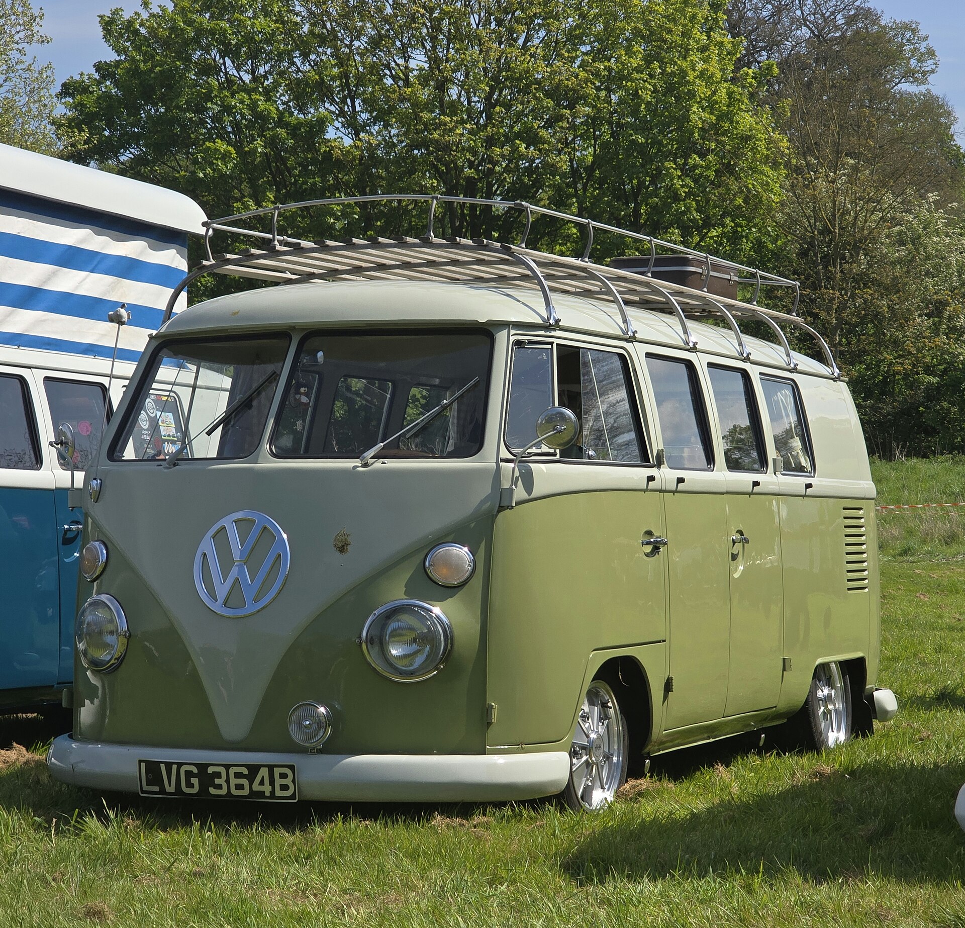 Front three-quarter view of a green and white 1964 Volkswagen Type 2 passenger bus